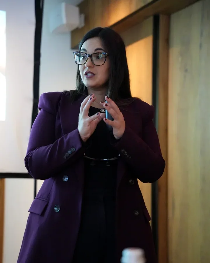 Dr. Andi-Jean Miro explaining her cosmetic dentistry protocol to a class